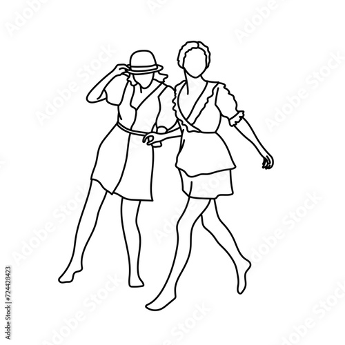 Deux amies se balladent pied nu dans le sable