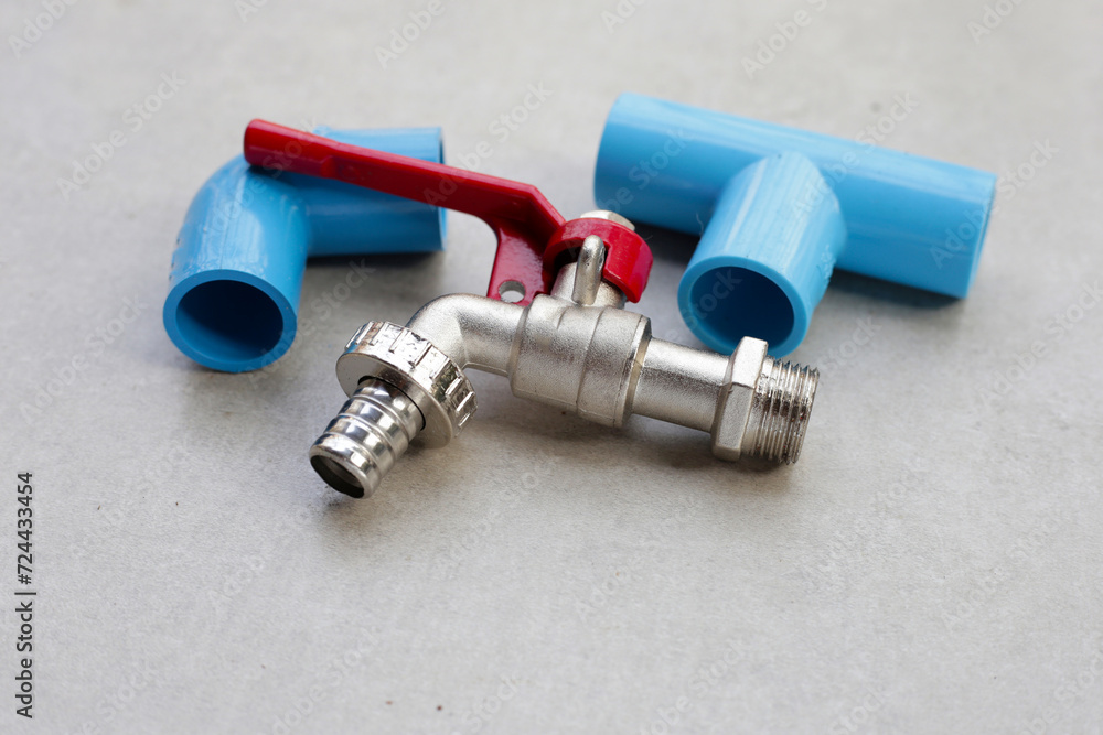 Faucet with blue pvc pipe connections for plumbing work. Faucet with blue pvc pipe connections for plumbing work.