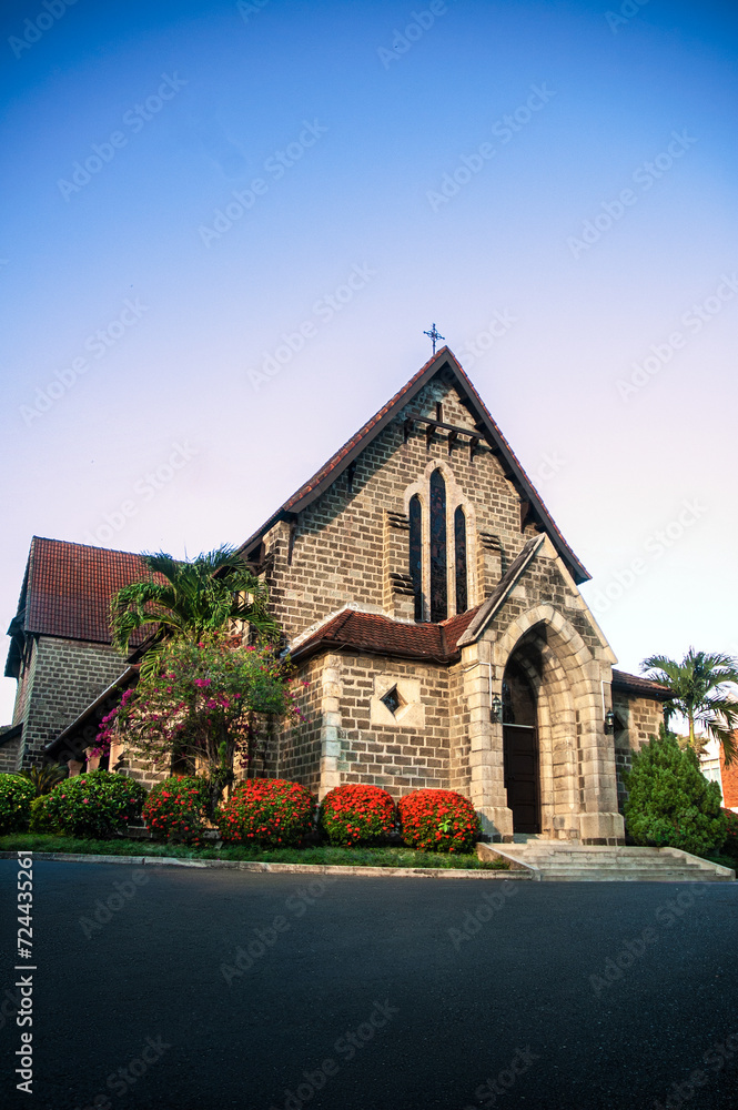 St. Michael's and All Angels Church, Sandakan. The oldest stone church in Sabah. Historic sights and monuments of Sandakan. Beautiful Flowering Shrubs.