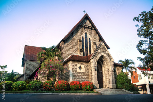 St. Michael's and All Angels Church, Sandakan. The oldest stone church in Sabah. Historic sights and monuments of Sandakan. Beautiful Flowering Shrubs.