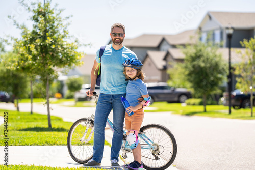 father and son enjoying a bicycle ride. outdoor activities. active son and father duo cycling through scenic countryside on bicycle. father teaching his son to ride a bicycle. father and son outdoor