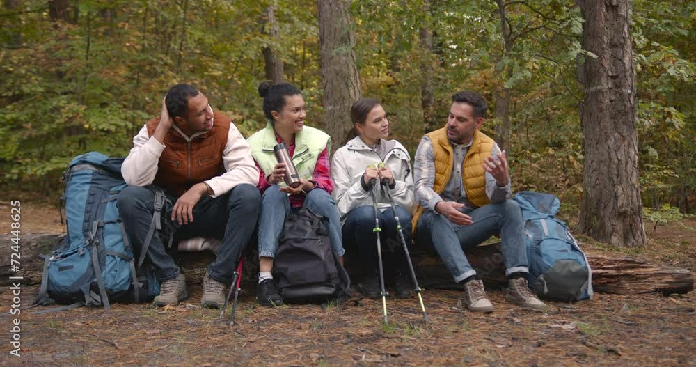 Group of friends hikers having break in autumn forest