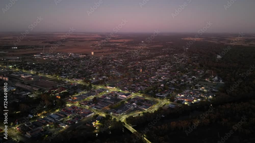 Drone hyperlapse of illuminated cityscape view and small water canal at sunset Drone hyperlapse of illuminated cityscape view and small water canal at sunset