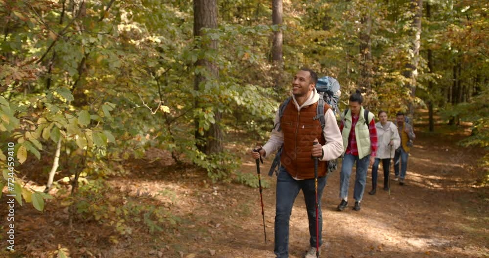Group of friends hiking together in autumn forest Group of friends hiking together in autumn forest