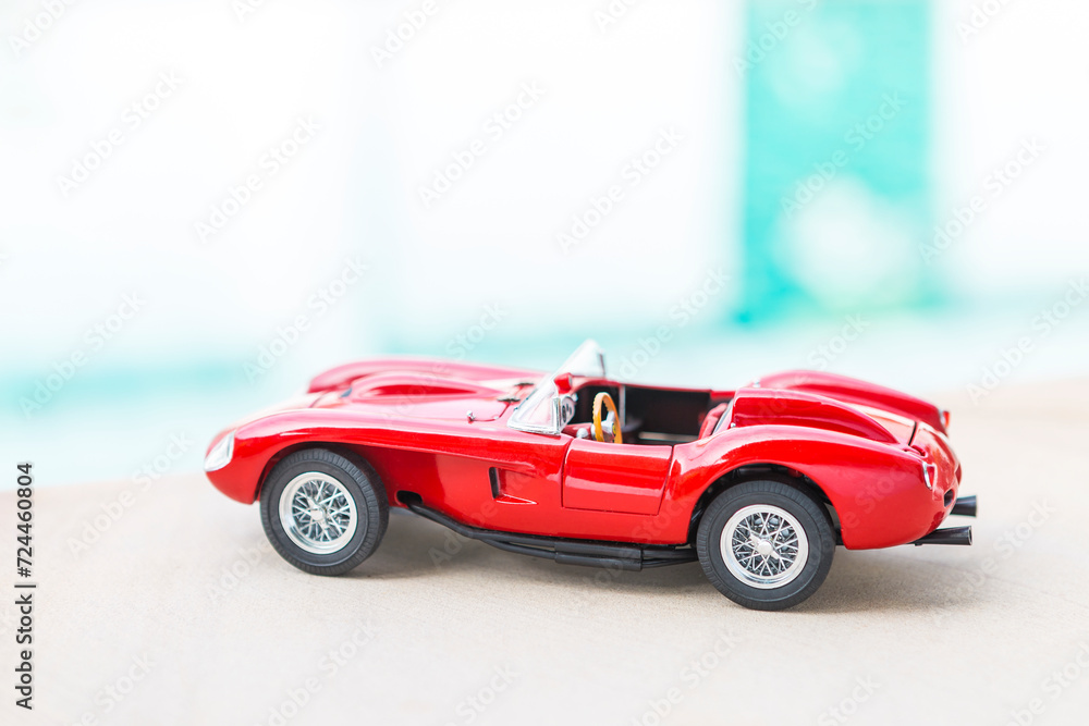 Fototapeta premium Sport car model on swimming pool edge with space on blurred background, outdoor day light