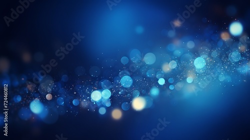 Blue glowing particles on dark background with bokeh effect
