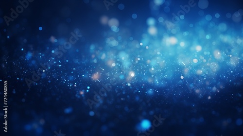 Blue glowing particles on dark background with bokeh effect