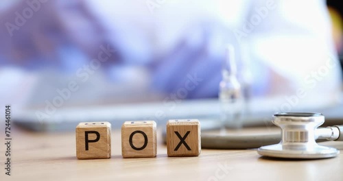 Word pox and doctor with ampoule and syringe. Smallpox vaccine concept photo