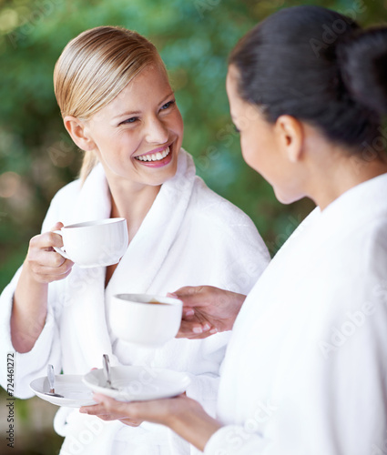 Spa, friends and happy women drinking coffee for health, wellness and skincare treatment. Girls, tea cup and salon for beauty, luxury body therapy in bathrobe and diverse people relax together