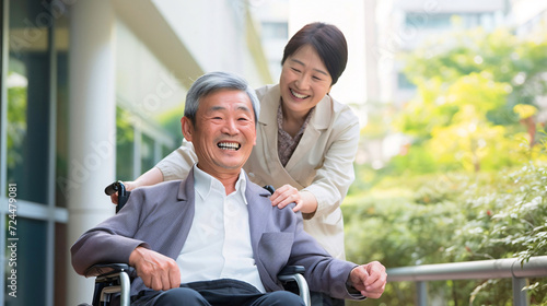 シニアと介護、車椅子に乗る日本人男性と介護士の女性 photo