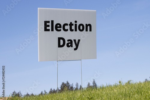 Election Day lawn sign against clear blue sky background.