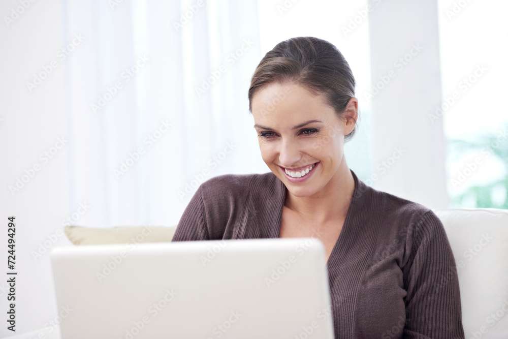 Woman, smile and laptop on sofa for remote work, update blog post or reading news on social media at home. Happy freelancer, computer and download with internet and movie subscription in living room Woman, smile and laptop on sofa for remote work, update blog post or reading news on social media at home. Happy freelancer, computer and download with internet and movie subscription in living room