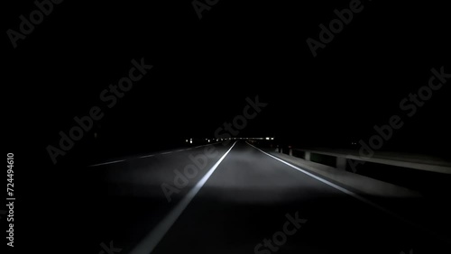 driving a car on countryside road at night with adaptive matrix headlights photo