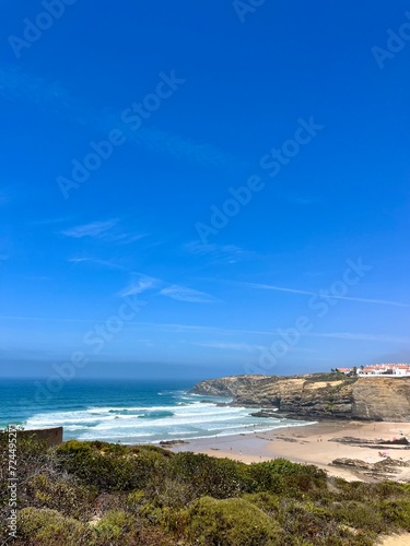 Rocky ocean coast  ocean bay with rocky coast and sand beach  blue sky  no people