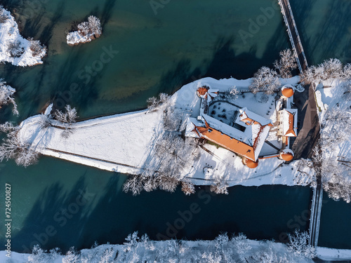 Majestic aerial view of Otocec castle on the island on Krka River, Slovenia during winter