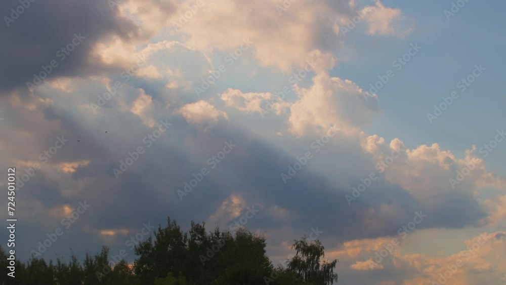 Calm evening sky with clouds and rays of light in orange tones. Calm evening sky with clouds and rays of light in orange tones.