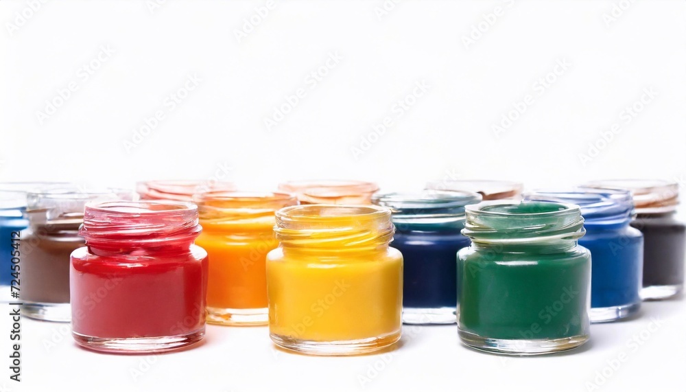 Multicolored paints in small glass jars. Multicolored paints in small glass jars.