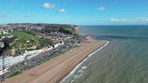 Aerial drone shot of Hastings UK, High Wide Angle Shot of Beach, Old Town and East Hill Cliffs. Camera Stationary above water. ENGLAND UK 4K DRONE AERIALS photo