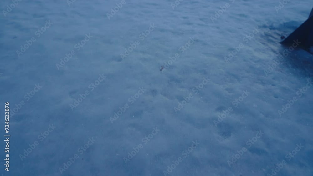 POV swinging on swing outdoors in winter. Feet wearing boots flying in air on antarctic north swing. Enjoy snow. A man in winter boots swings against backdrop of a landscape of a white frozen ocean POV swinging on swing outdoors in winter. Feet wearing boots flying in air on antarctic north swing. Enjoy snow. A man in winter boots swings against backdrop of a landscape of a white frozen ocean