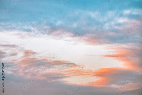 A beautiful sky tinted by the sun leaving vibrant shades of gold, pink, blue and multicolored. Clouds in the twilight evening and morning sky. Cloudy sky background in the evening and during the day.