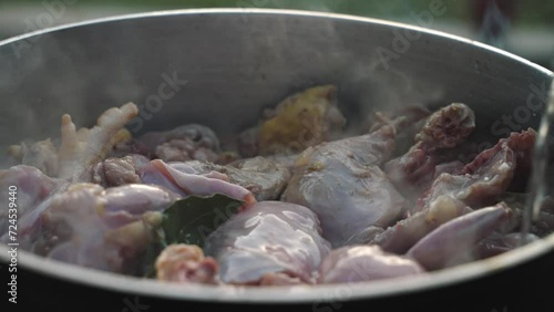 Adding Wine to Chicken in Large Cooking Pot photo