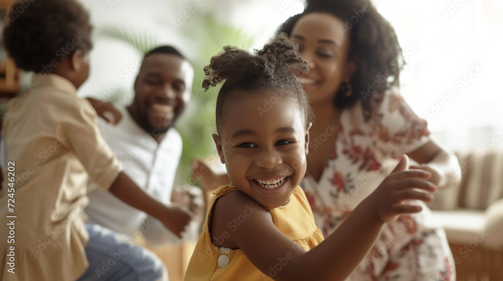 Happy child dancing with family in big cozy room. Happy child dancing with family in big cozy room.