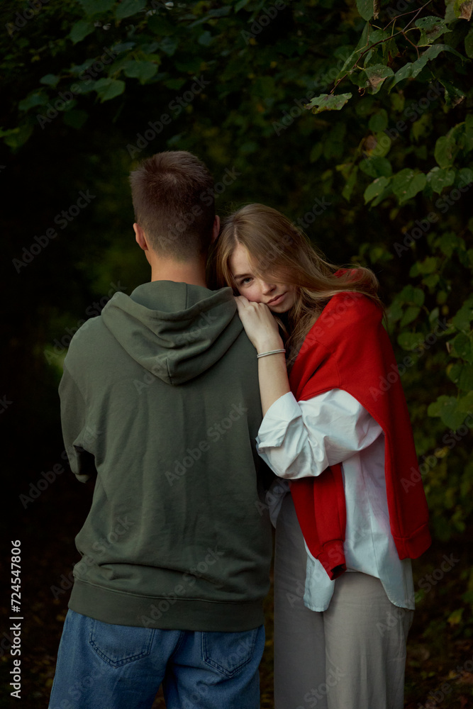 Fototapeta premium young teen couple hug and play in park