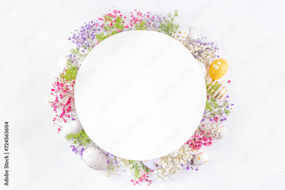 Happy Easter greeting card background with easter eggs and spring flowers. Easter holiday flat lay composition with copy space for text