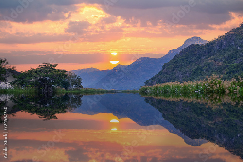 Landscape evening view golden sunset over the river with beautiful mountain seen and background. Beauty and nature concept. 