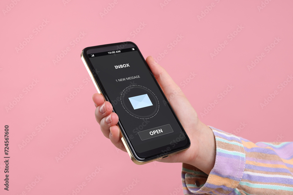 Got new message. Woman holding smartphone on pink background, closeup Got new message. Woman holding smartphone on pink background, closeup