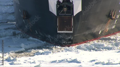 Close-up of the bow of an oil tanker - icebreaker sailing on a sea covered with ice photo
