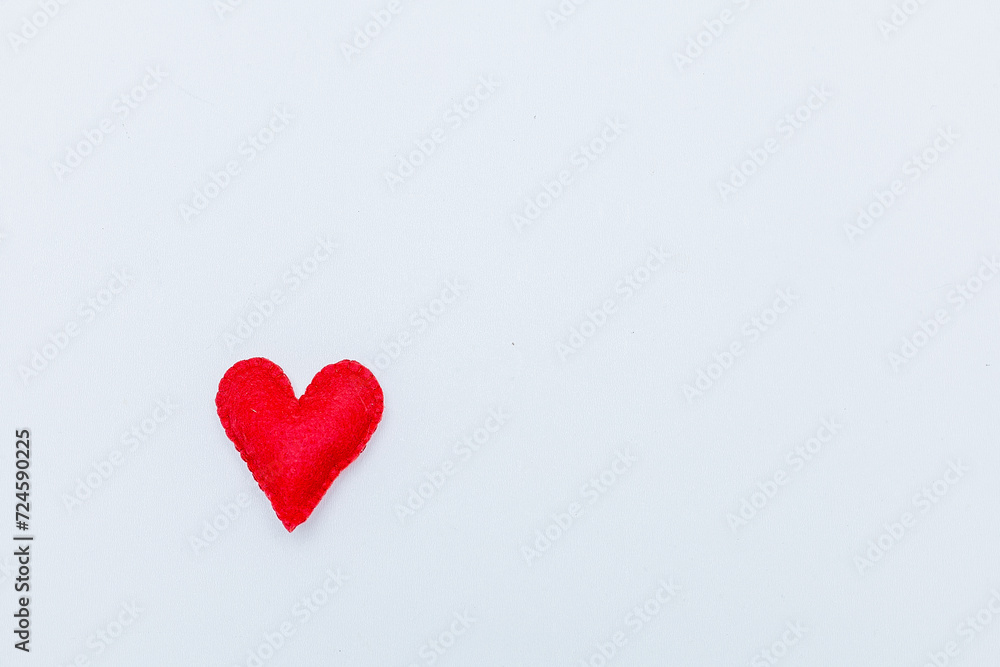 Frame from red felt hearts on white background. St. Valentine's Day concept. Top view, copy space