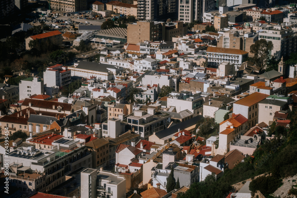 Gibraltar, Britain - January 24, 2024 - An aerial view of a dense urban area with varied architecture, including traditional and modern buildings, under bright sunlight.