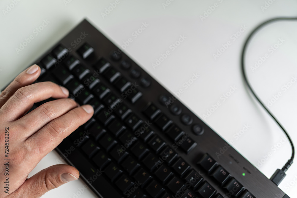 Left hand of a gamer on the keyboard. On the W, A, S and D keys
Left hand of a gamer on the keyboard. On the W, A, S and D keys