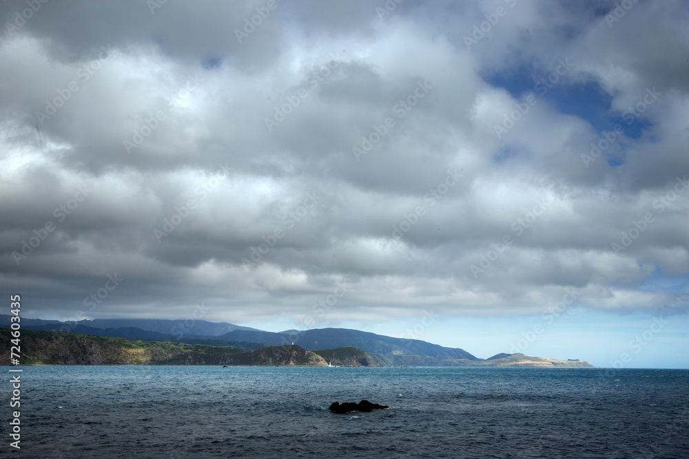 Rocky coast at Breaker Bay. Wellington New Zealand. Tasman Sea. Clouds.