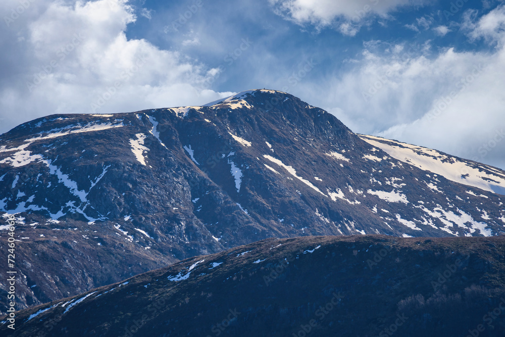 Western cap in Norway. Snow-covered mountain peaks. Very cloudy sky. Landscape Western cap in Norway. Snow-covered mountain peaks. Very cloudy sky. Landscape