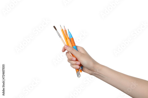 PNG,a female hand holds a brush and pencils, isolated on white background