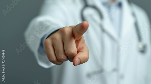 doctor pointing in hospital environment, front view