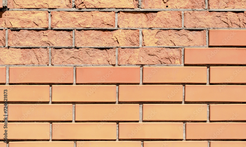 Fototapeta premium texture orange brick wall with damaged fragments