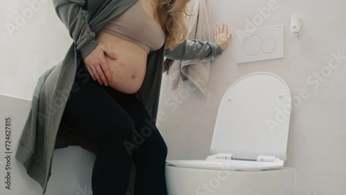Unrecognizable pregnant woman having morning sickness photo