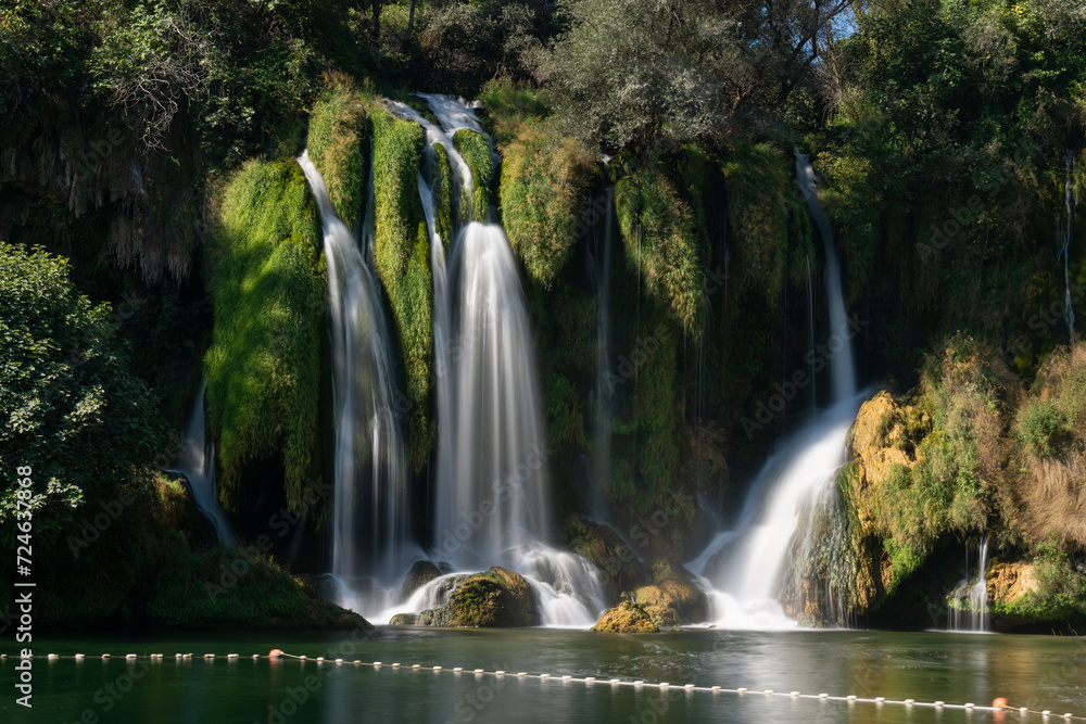 Kravice waterfalls on river Trebizat in summer during sunny day, long exposure with silky water