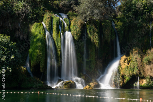 Kravice waterfalls on river Trebizat in summer during sunny day, long exposure with silky water