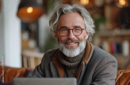 middle aged guy showing his face with laptop and smiling