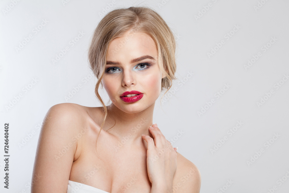 Prom woman with clean fresh skin and long curly hair looking at camera on white studio wall background, portrait Prom woman with clean fresh skin and long curly hair looking at camera on white studio wall background, portrait