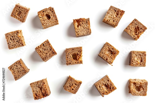 Assortment of homemade rye bread croutons isolated on white background Crispy cubes dry crumbs rusks croutons or roasted cracker pattern