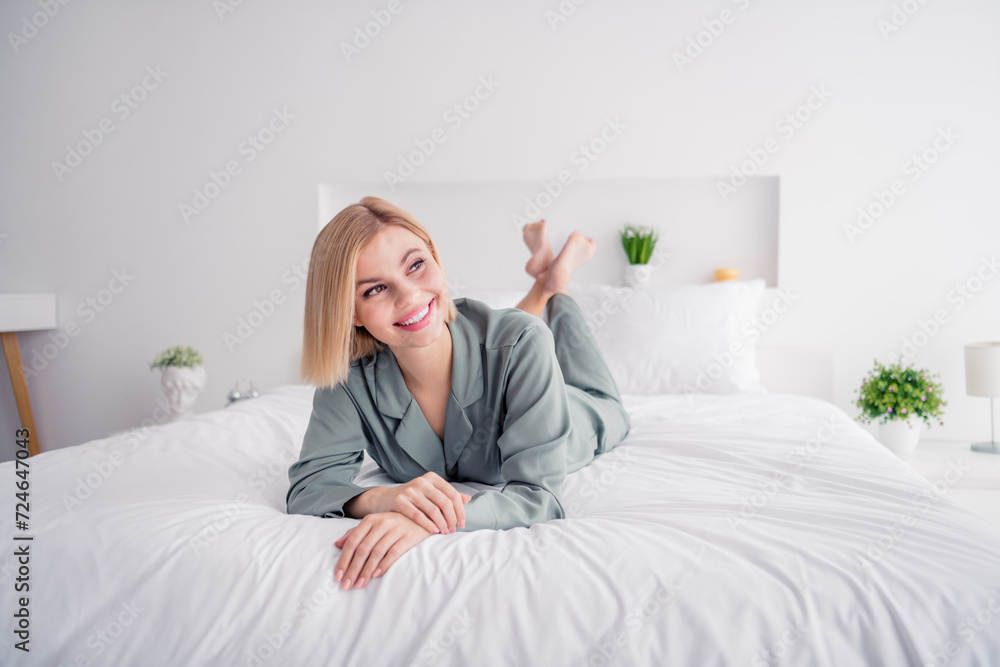 Photo of nice young blonde woman wear grey pajama looking dreamy window daylight her perfect soft bedroom white interior with decor Photo of nice young blonde woman wear grey pajama looking dreamy window daylight her perfect soft bedroom white interior with decor