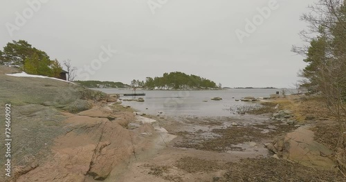 View of stony beach in cloudy spring weather at Lähteelä outdoor Rereation Area, Porkkala, Kirkkonummi, Finland. photo