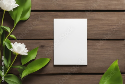 Blank card with white flowers on wooden background