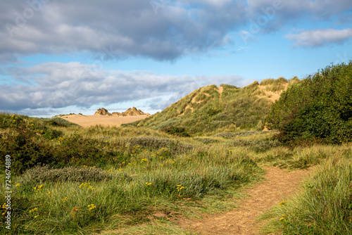 The sand dunes at Formby in Merseyside, with a blue sky overhead