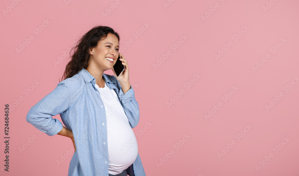 Happy young pregnant woman have phone conversation Happy young pregnant woman have phone conversation